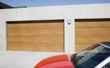 Deux portes de garage sectionnelles imitation bois dans un garage double